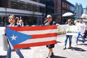 Protesters rally outside John Joseph Moakley Courthouse as a Boston federal judge presided over a hearing on Puerto Rico’s debt and bankruptcy on Monday. Banner Photo
