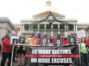 Demonstrators led by Community Labor United marched through downtown Boston to the State House to demand passage of an anti-wage theft bill. Photo: Saphia Suarez