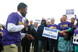 Demonstrators gather in front of the Whittier Street Health Center Friday to protest the firing of 13 staff members. photo credit: Saphia Suarez