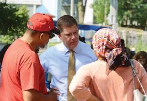 Mayor Martin Walsh meets with Roxbury residents during a neighborhood coffee hour in Gertrude Howes Playground. Residents of the neighborhood expressed concerns about a sober home operator looking to open a home in the area. photo: Mayor’s Office photo by Isabel Leon