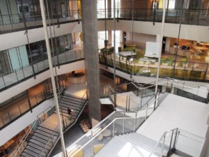 The building’s four-story atrium reveals classrooms and shared work spaces. Light penetrates through a skylight as well as through the street-facing classroom windows. Banner Photo