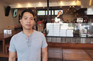 Eric Ly inside Coco Leaf Dessert Café in Dorchester. Banner Photo