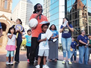 Sprinkler Fitters union member Chaton Green speaks during a rally in Copley Square. Banner Photo