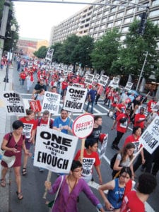 Massachusetts Avenue; Brian Lang addresses demonstrators outside the lobby of the Sheraton Hotel. Banner Photo