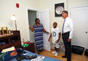 Patricia Brown’s grandson shows the mayor his new room at home in Olmsted Green, challenges him to a dunk contest. photo: Mayor’s Office Photo by John Wilcox