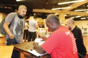 Unite Here Local 26 workers turn out to vote at strike headquarters on West Street in downtown Boston. Photo: Catherine McGloin