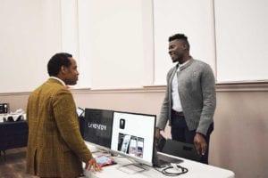 Adam Taylor, founder of Langston Corporation, talks with an attendee at the third annual LISC Boston Founders Stage Pitch Competition. PHOTO: KAREN MORALES