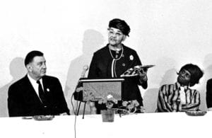 Melnea Cass shares the podium with Franklin D. Roosevelt, Jr. and Lena Saunders during a senior citizens meeting in Roxbury. BANNER FILE PHOTO