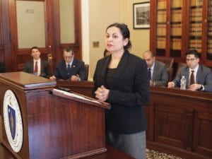 Gaston Institute Director Lorna Rivera speaks during a presentation at the State House. BANNER PHOTO