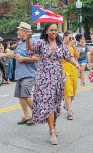 Congresswoman Ayanna Pressley waves a Puerto Rican flag during the Festival Betances parade. PHOTO: CELINA COLBY