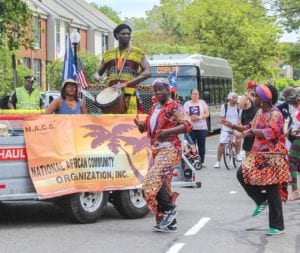 National African Community Organization representatives walk in the Festival Betances parade. PHOTO: CELINA COLBY