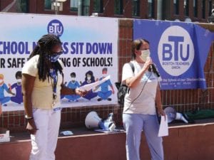 Tobin School Nurse Katie Mallon addresses school nurses gathered on City Hall Plaza who are calling for schools to remain closed until safety protocols are in place. BANNER PHOTO