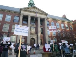 Parents at Boston Latin School demonstrate against a proposed one-year change in the admissions policy for the city’s three selective admissions schools. BANNER PHOTO