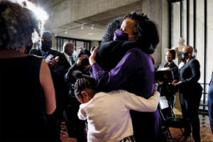 Janey’s daughter Kimesha Janey and granddaughter, Rosie, embrace after her swearing in.