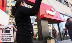 Demonstrators picket in front of the PUMA outlet in Somerville.  