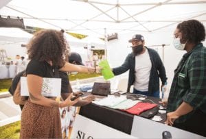 Shoppers browse products at a Black Owned Bos. open market in the Seaport.