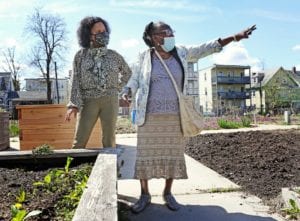 Acting Boston Mayor Kim Janey talks with Yemi Ajayi about gardening at Nightingale Community Garden in Dorchester.