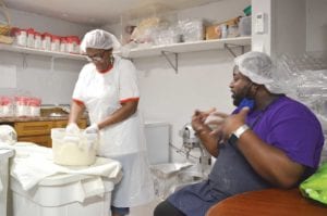 Violet Francis, 66, with her son, Valroyce Francis, 31, in the kitchen at her restaurant, Auntie Vie’s Bakery & Restaurant, in Dorchester. Photo: Tori Bedford GBH News